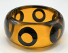 Evans 7 transparent amber bangle w black octopus eyes